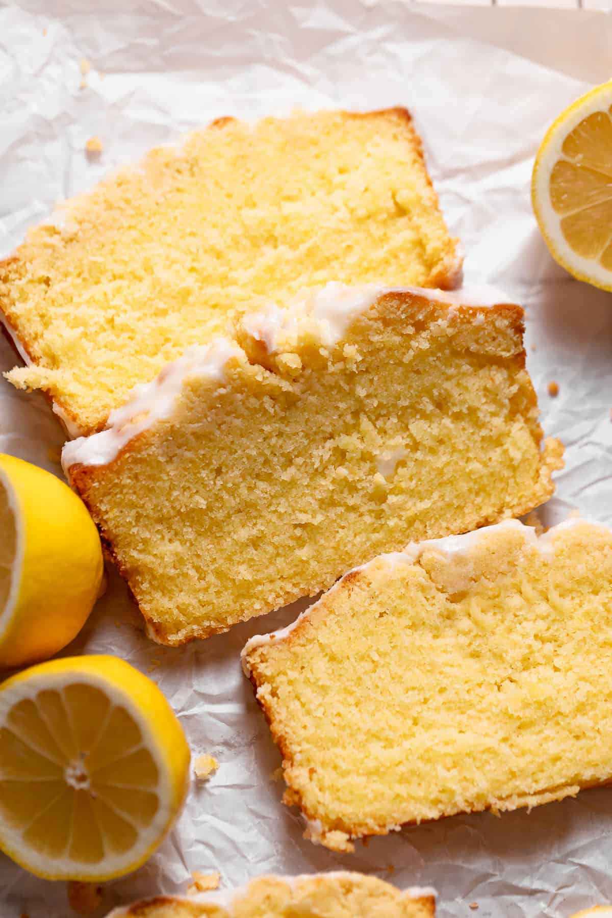 Lemon cake slices on white parchment paper.