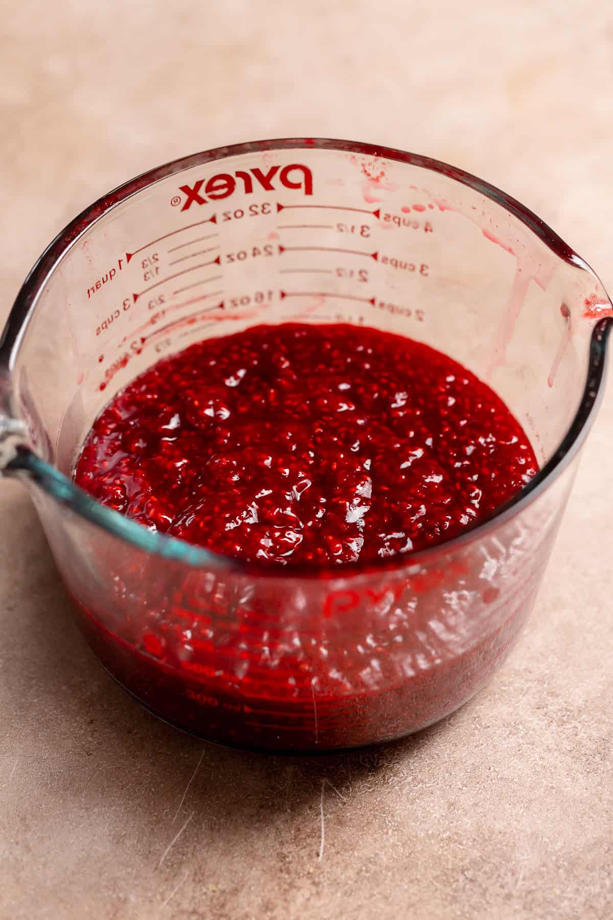 Raspberry jam filling in a glass bowl.