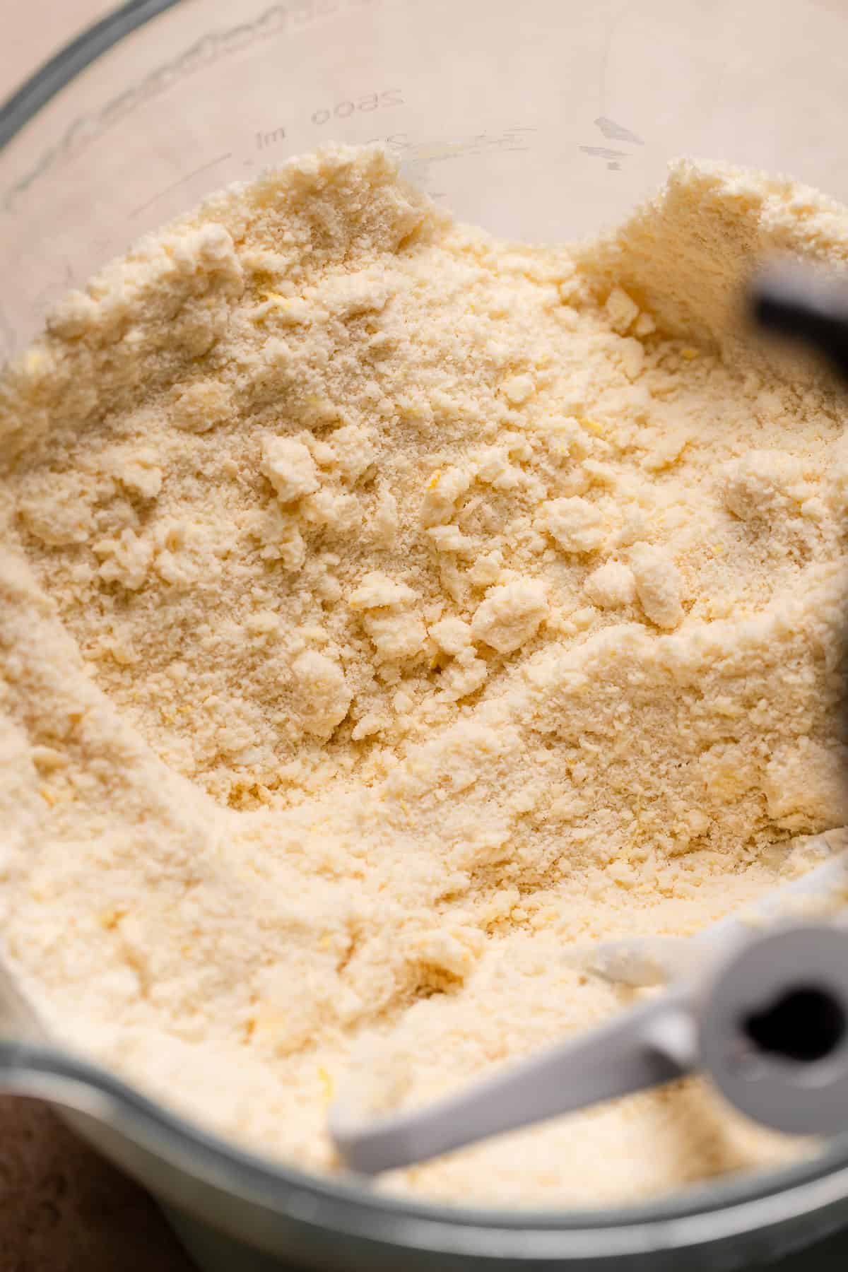 A mixing bowl with the sandy butter and flour mixture.