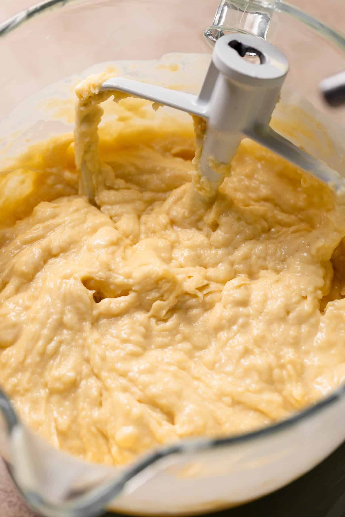 Lemon cake batter in a glass mixing bowl.