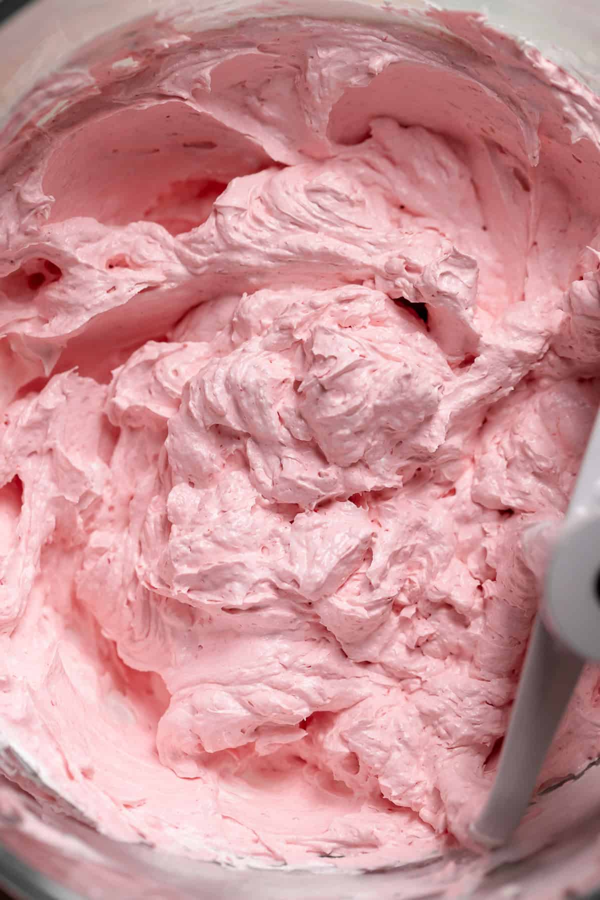 Pink swiss meringue buttercream after mixing in the raspberry jam.