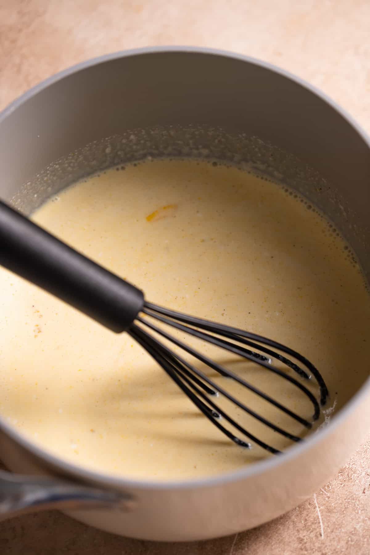 Eggs and cream being cooked together in a pot.