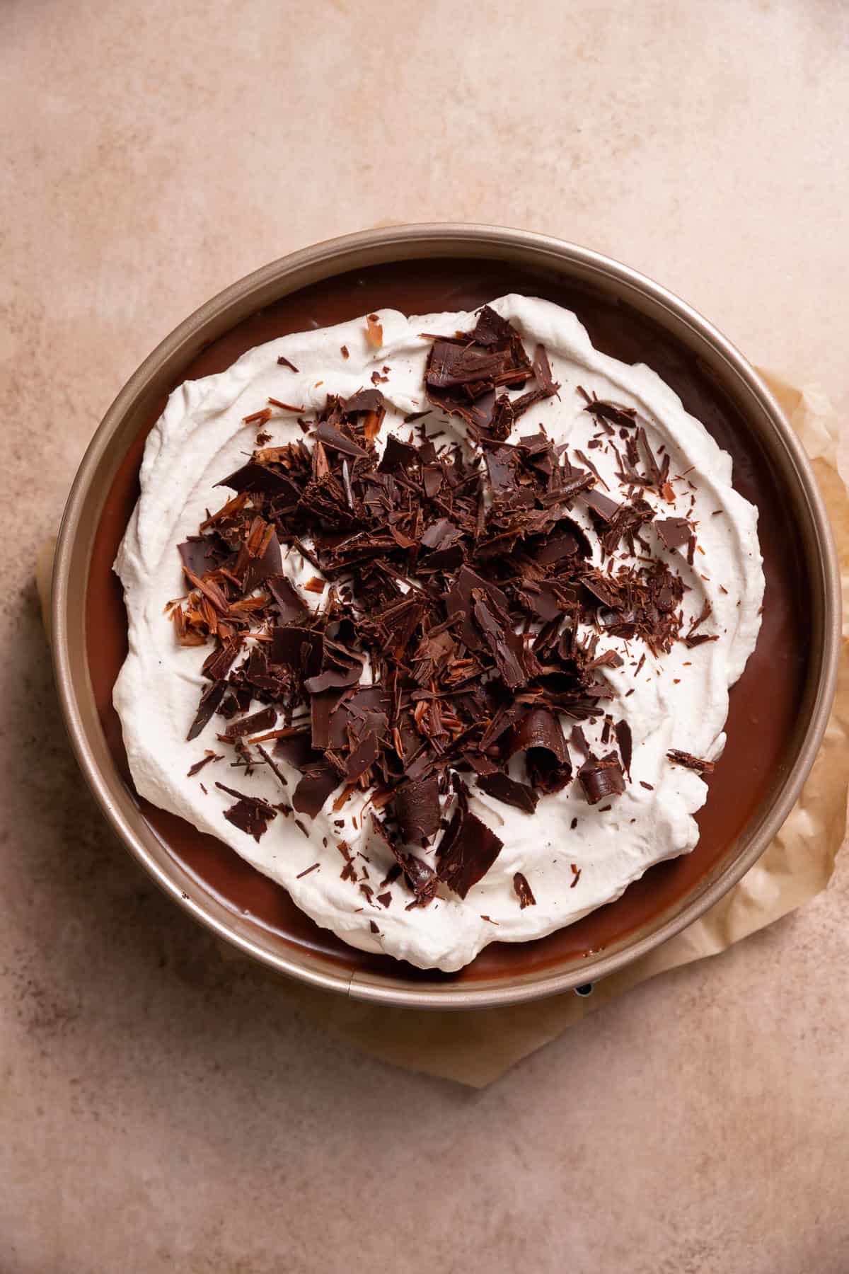 Chocolate mousse pie topped with whipped cream and chocolate curls.