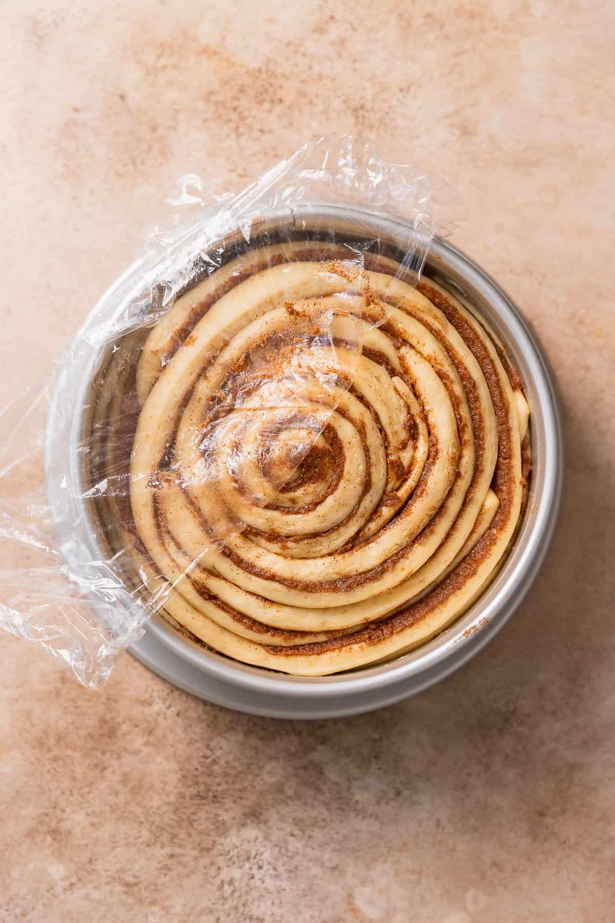 The cinnamon bun in a pan doubled in size right before baking.