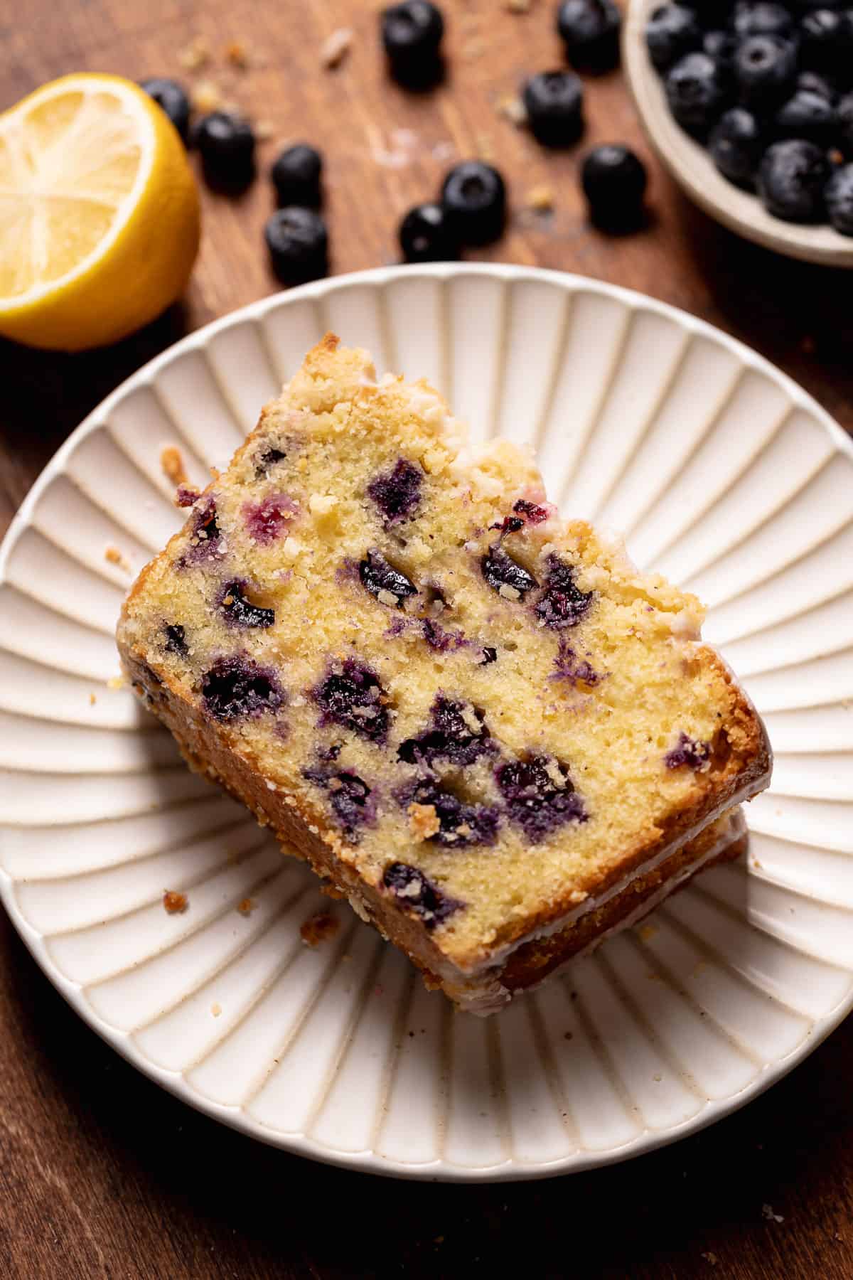 A slice of lemon blueberry cake on a plate.