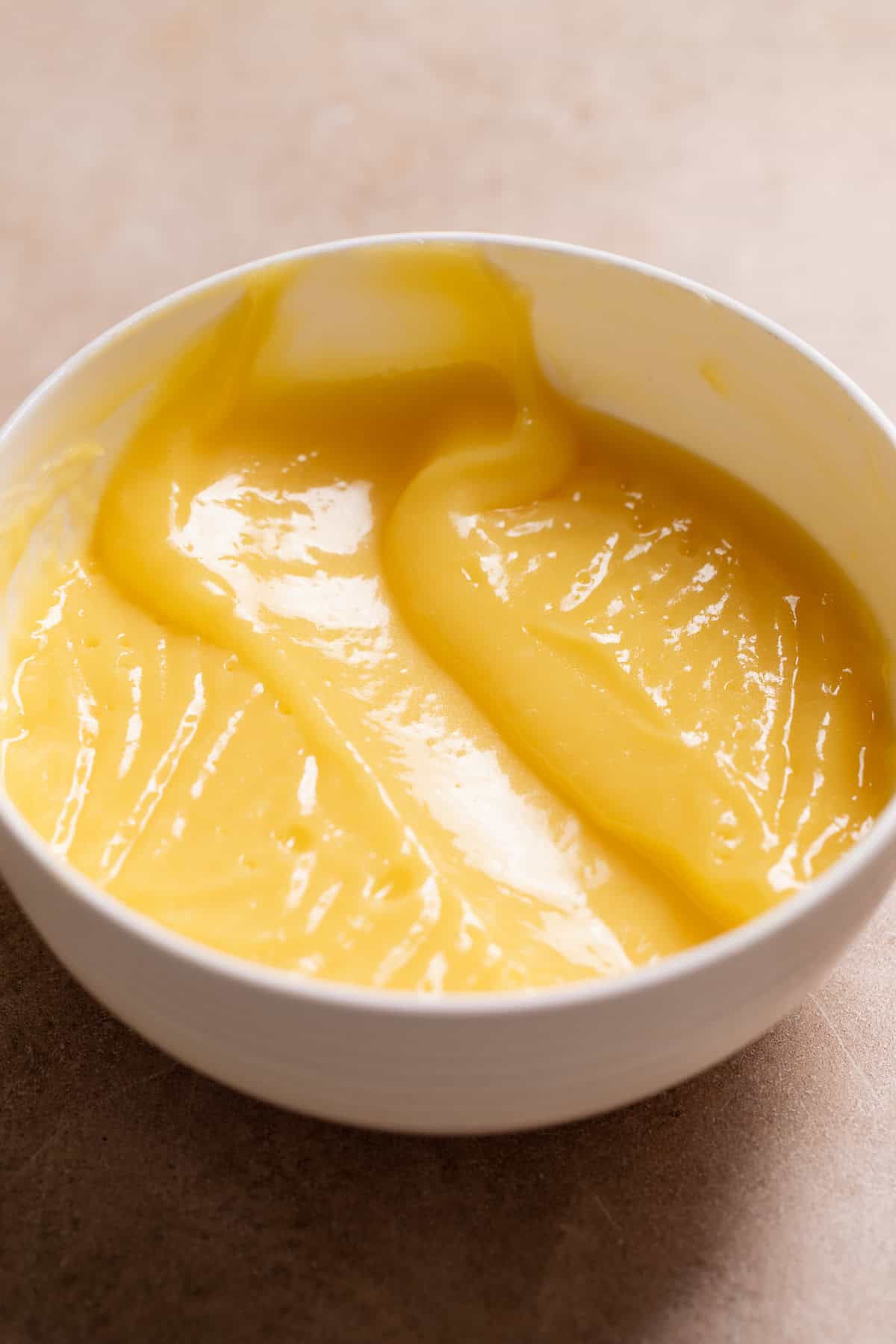 Lemon curd filling in a white bowl.
