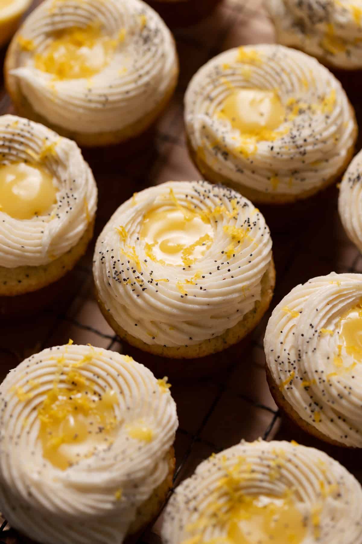 Lemon poppy seed cupcakes after decorating with poppy seeds and fresh lemon zest.