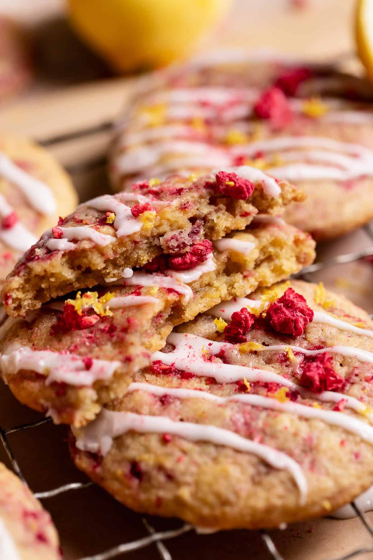 A raspberry cookie broken in half to show the soft gooey centers.