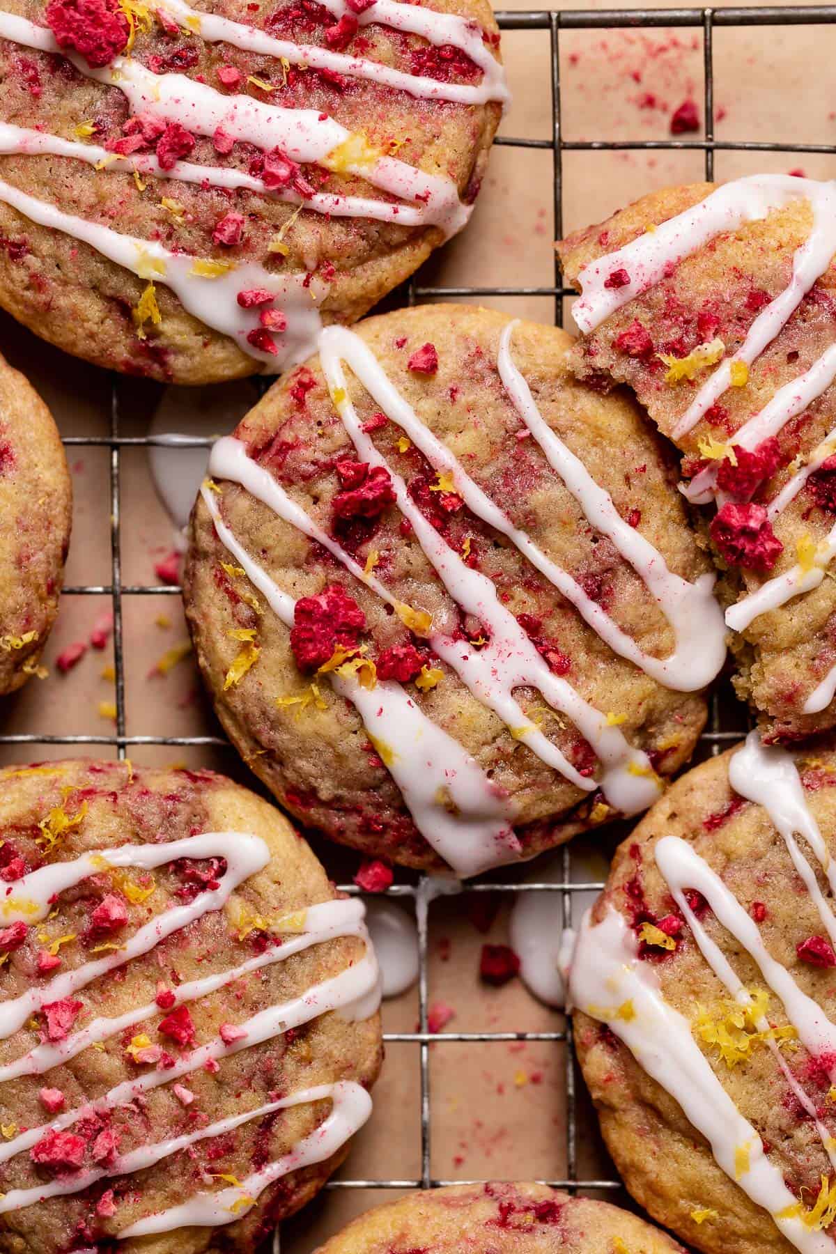 Lemon raspberry cookies with lemon icing and fresh lemon zest on top.