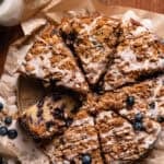 Slices of blueberry streusel coffee cake on brown parchment paper.