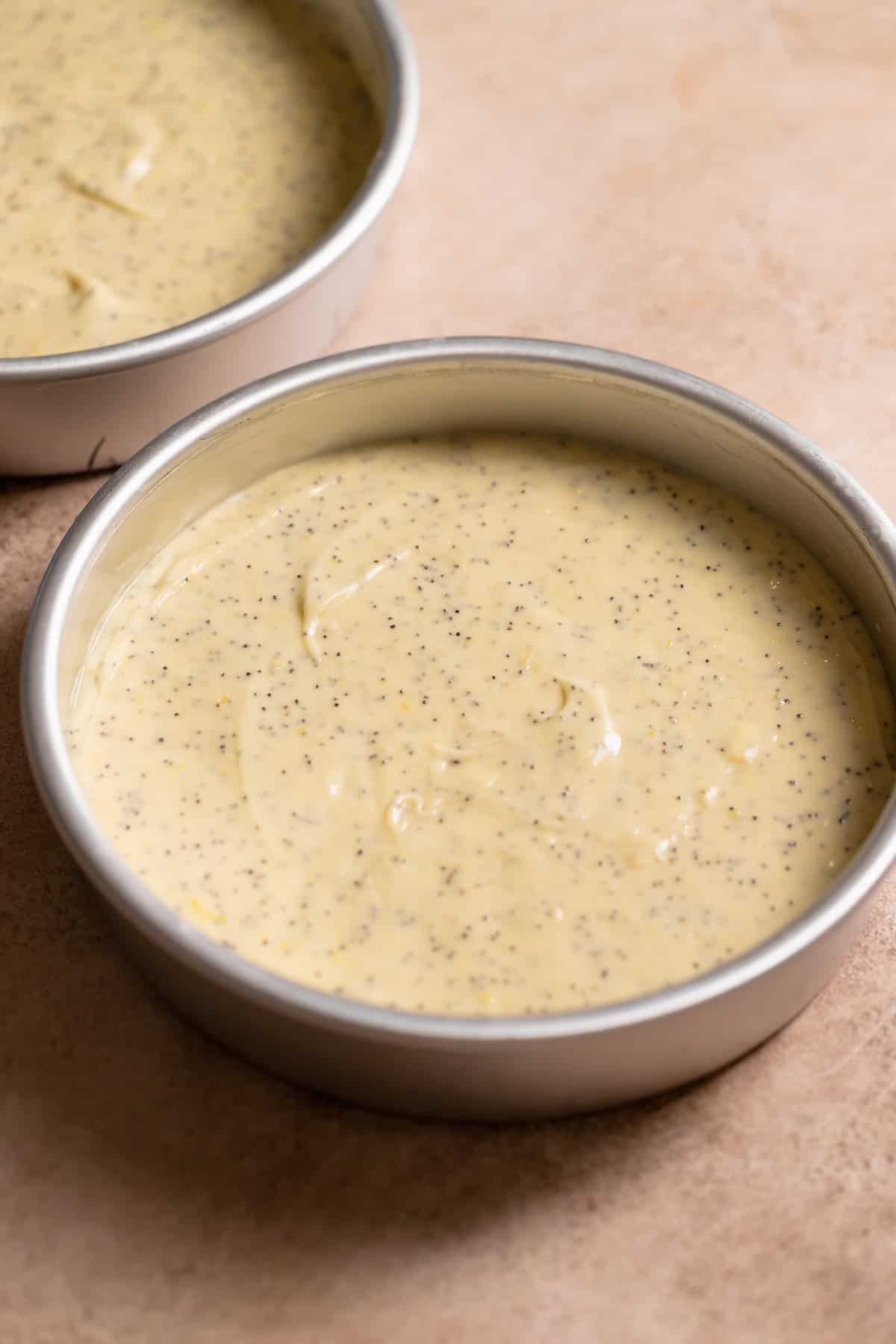 Cake pans full of lemon cake batter before baking.