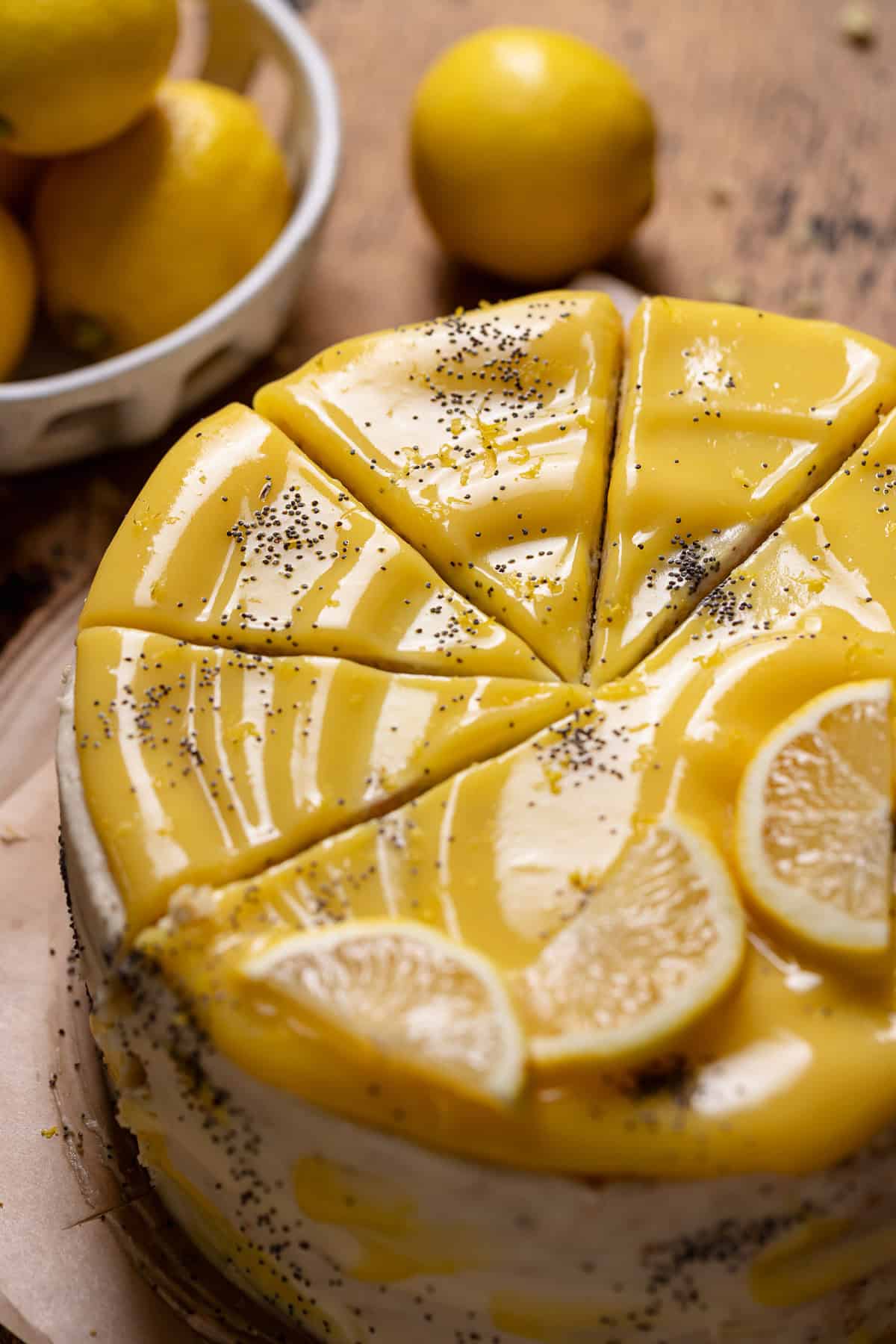 Lemon poppy seed cake with lemon curd on top cut into slices.