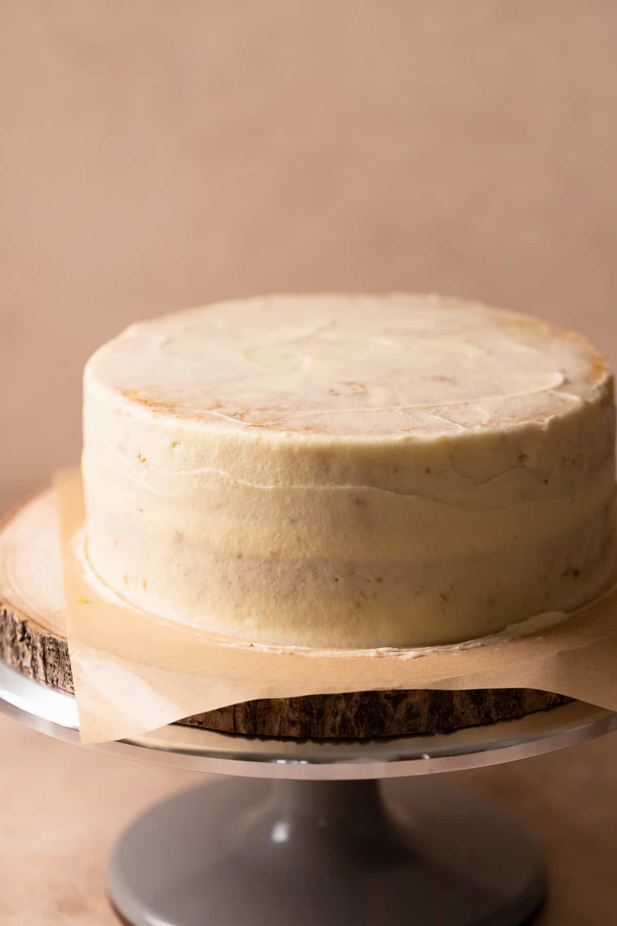 Lemon cake with a thin layer of cream cheese frosting covering it.