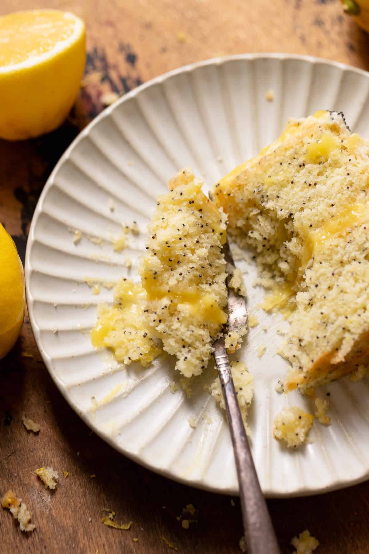 A bite of lemon poppy cake on a fork.