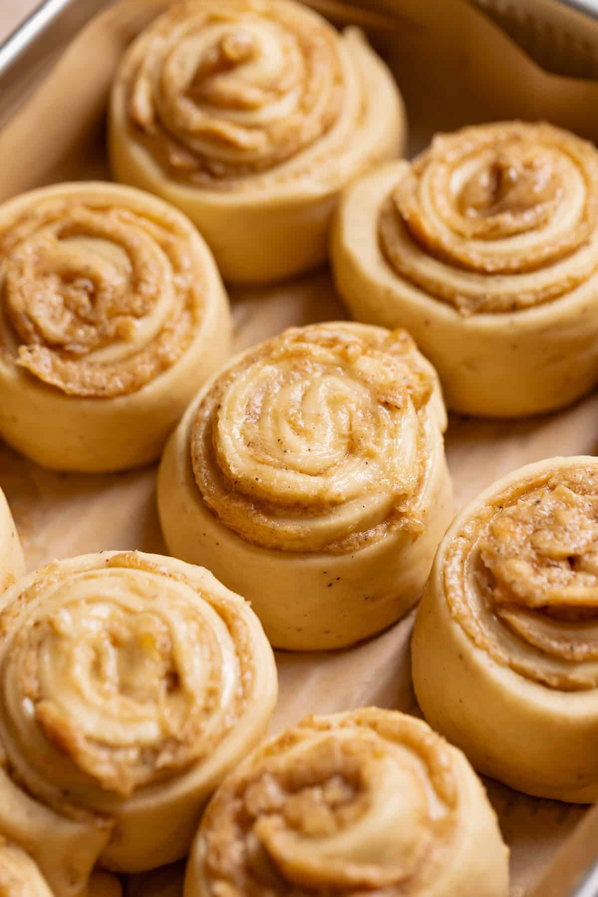 Banana pudding rolls doubled in size in a baking pan before baking.