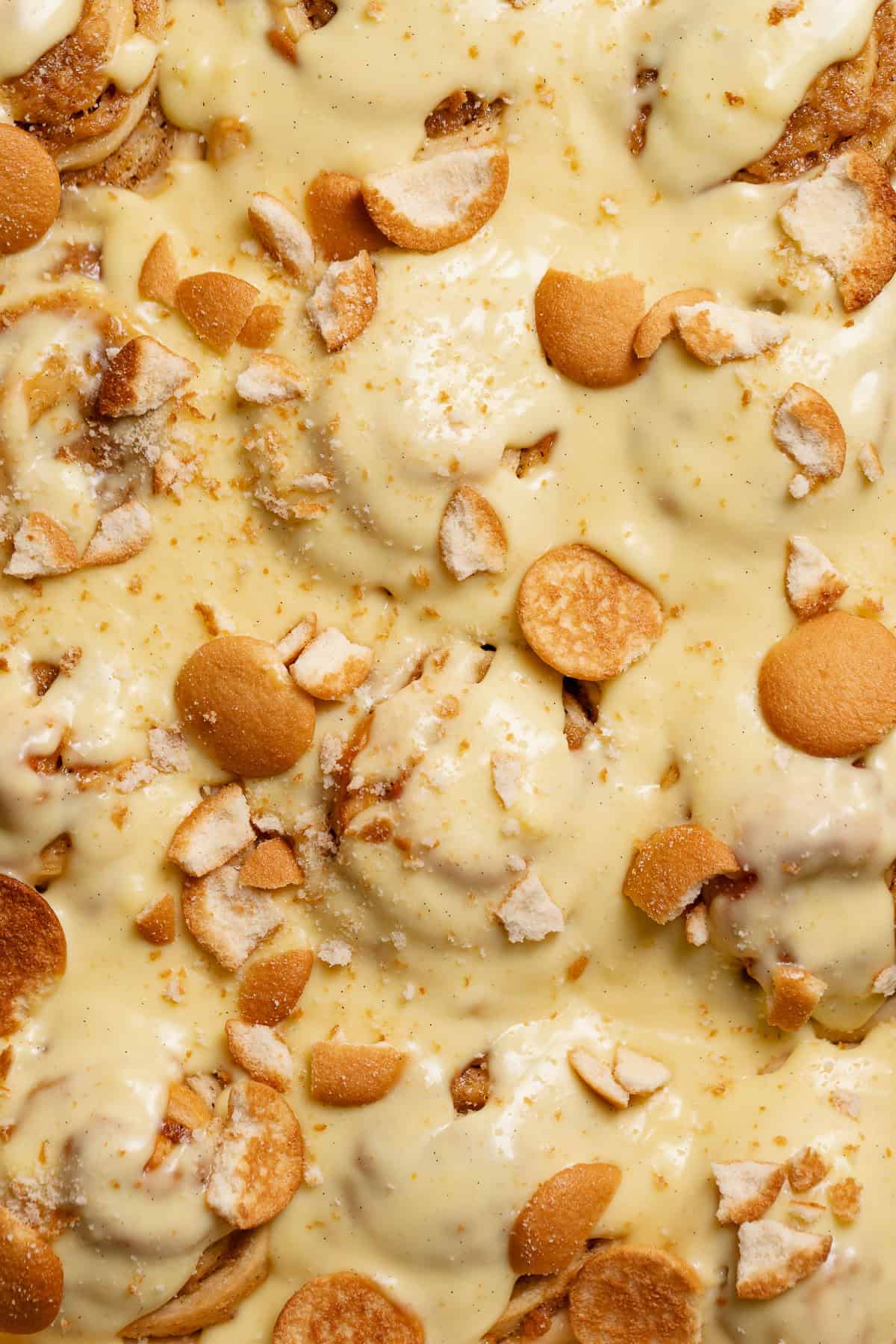 Banana pudding rolls drenched in vanilla pudding and topped with nilla wafers.