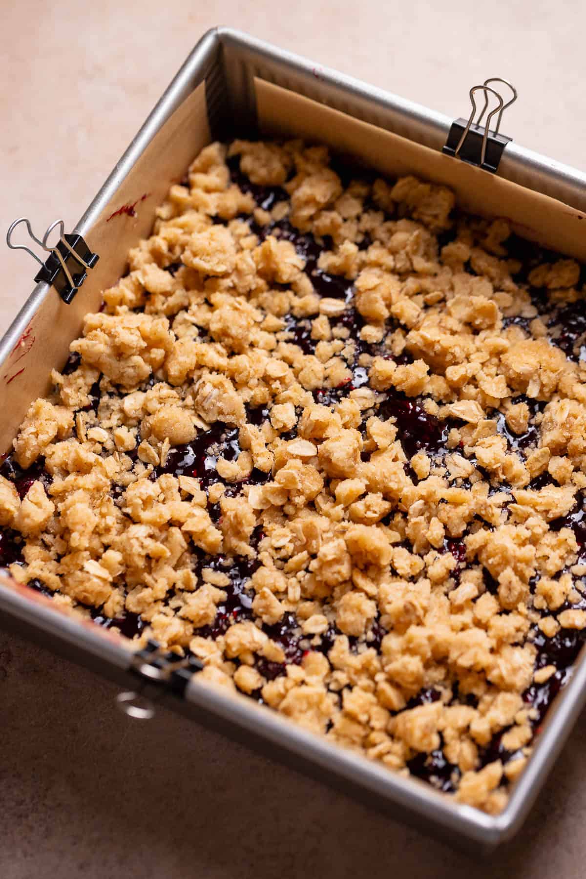 Berry crumb bars in a pan before baking.
