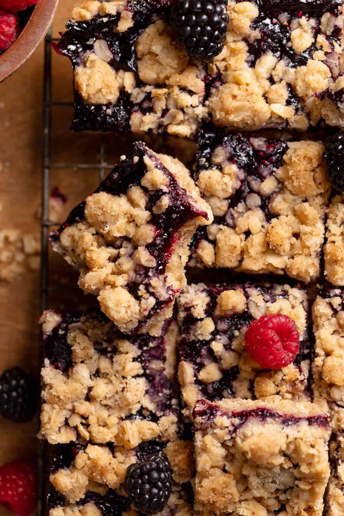 Mixed berry crumb bar with a bite taken out of it.