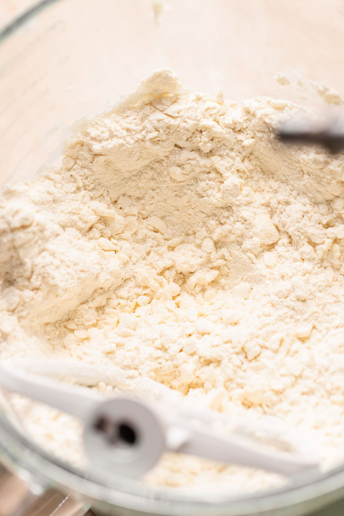 Flour and butter mixed to pea sized bits in a mixer bowl for the pie dough.