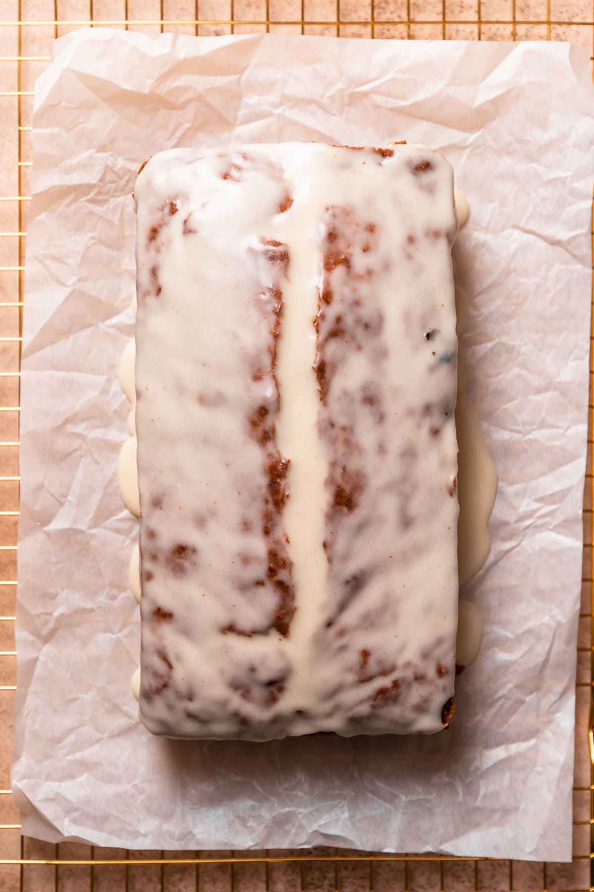The glazed brown butter banana bread loaf on parchment paper.