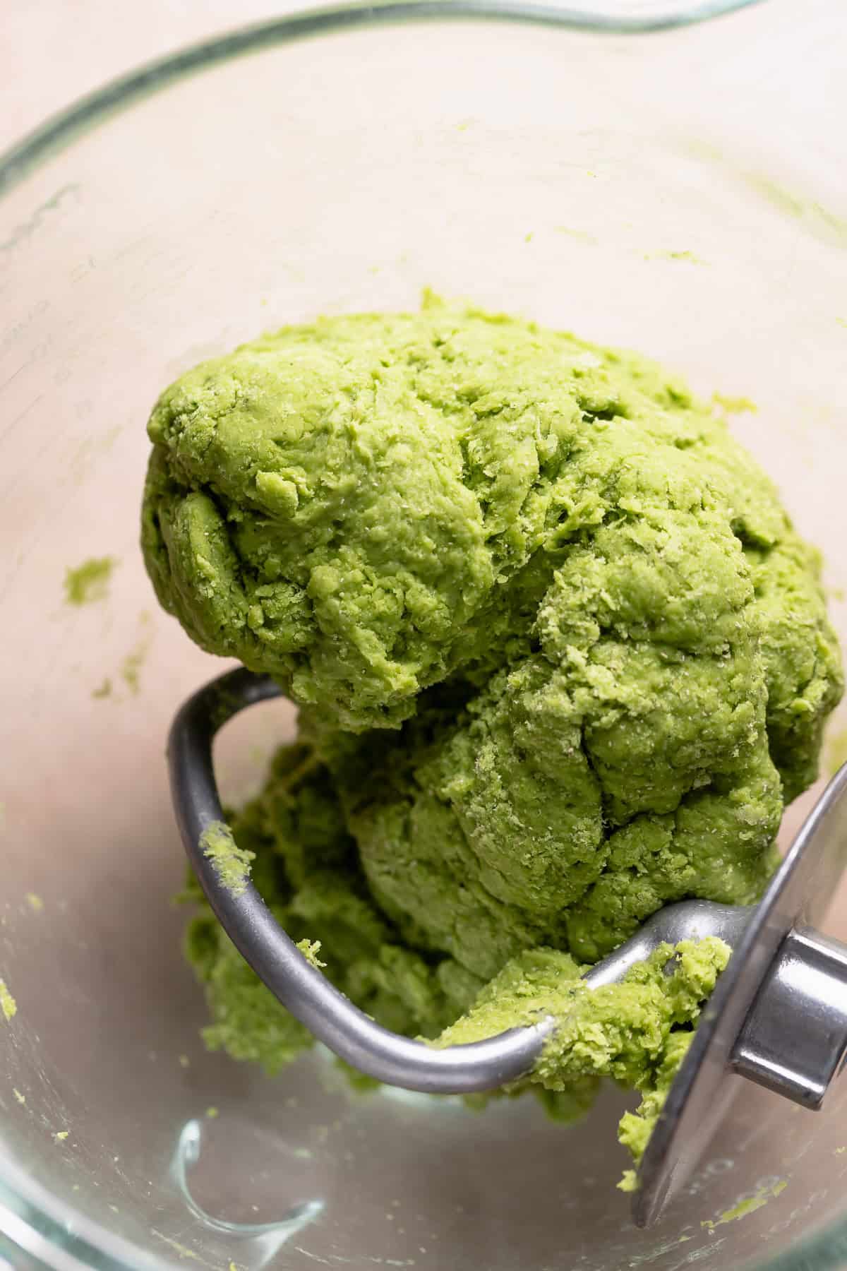 Matcha dough ball in a mixing bowl before kneading in the butter.