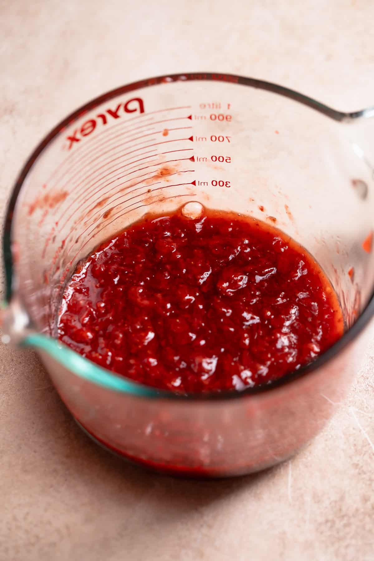 Strawberry jam filling in a glass bowl.