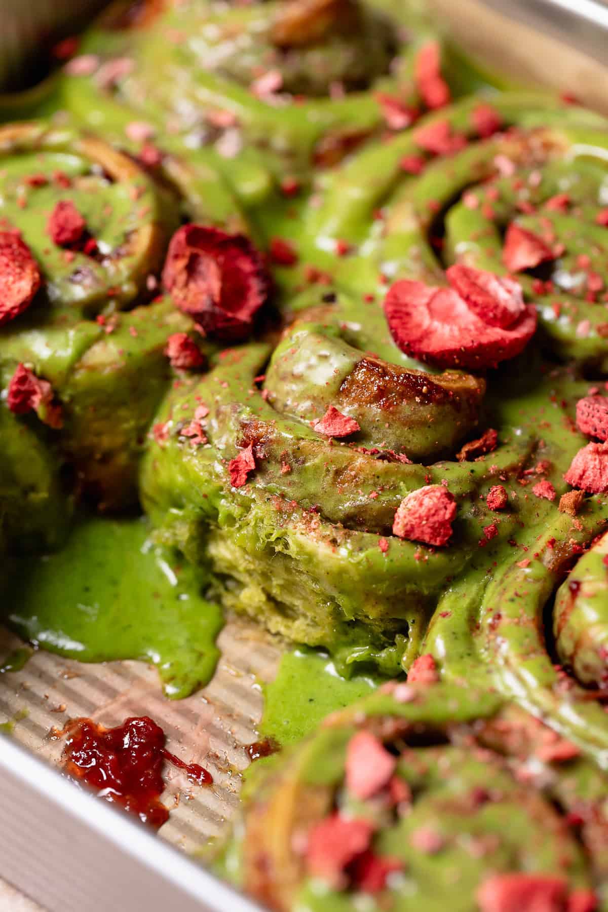 Matcha cinnamon rolls in a baking pan.