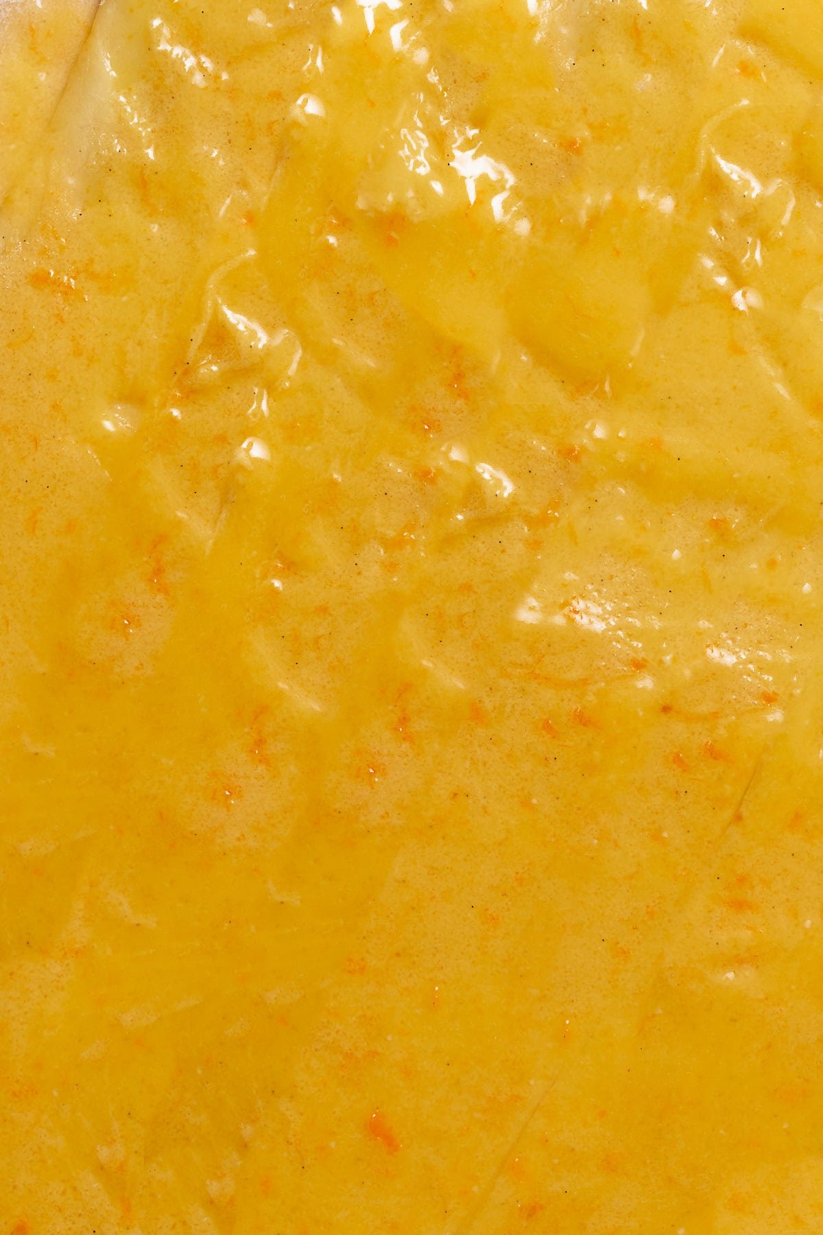 Orange curd and sugar filling spread onto the cinnamon roll dough.
