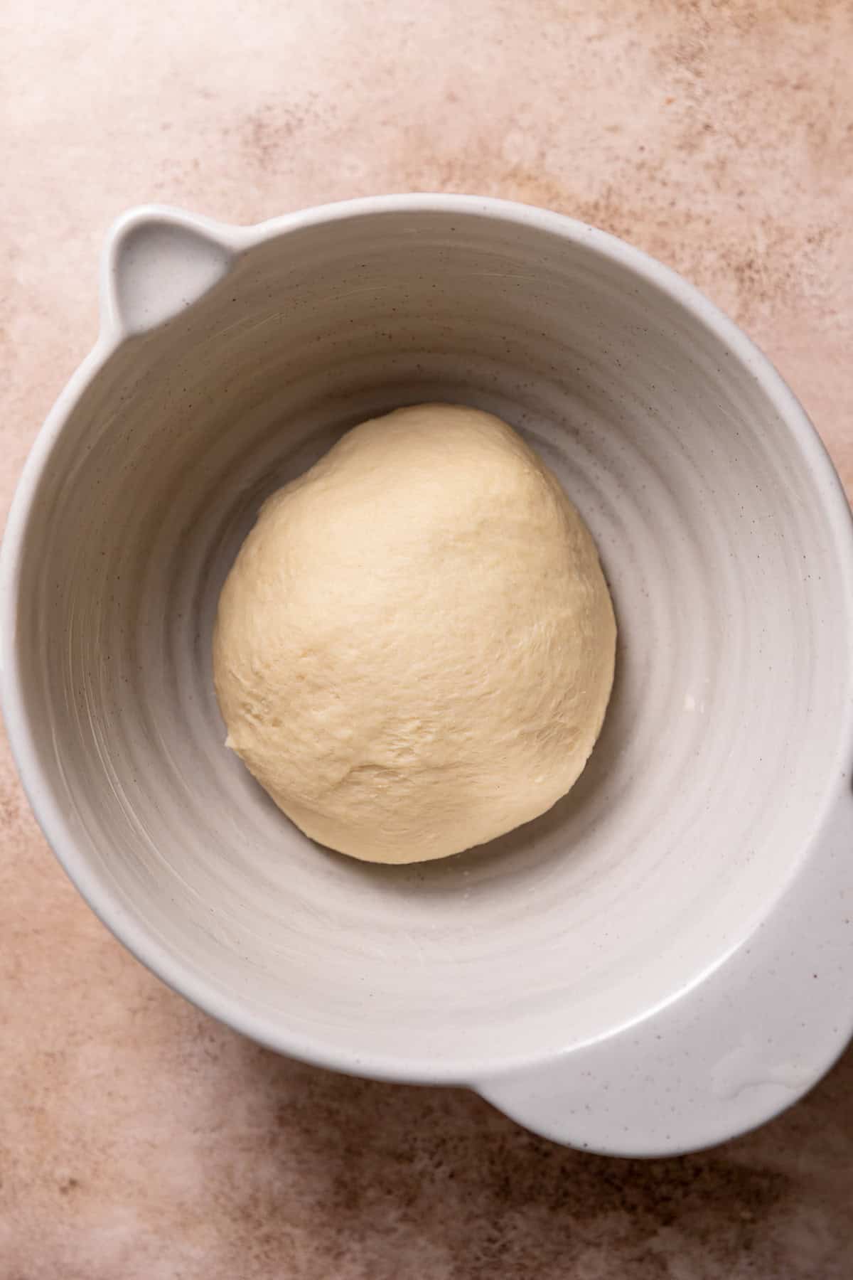 Soft smooth dough in a bowl resting.