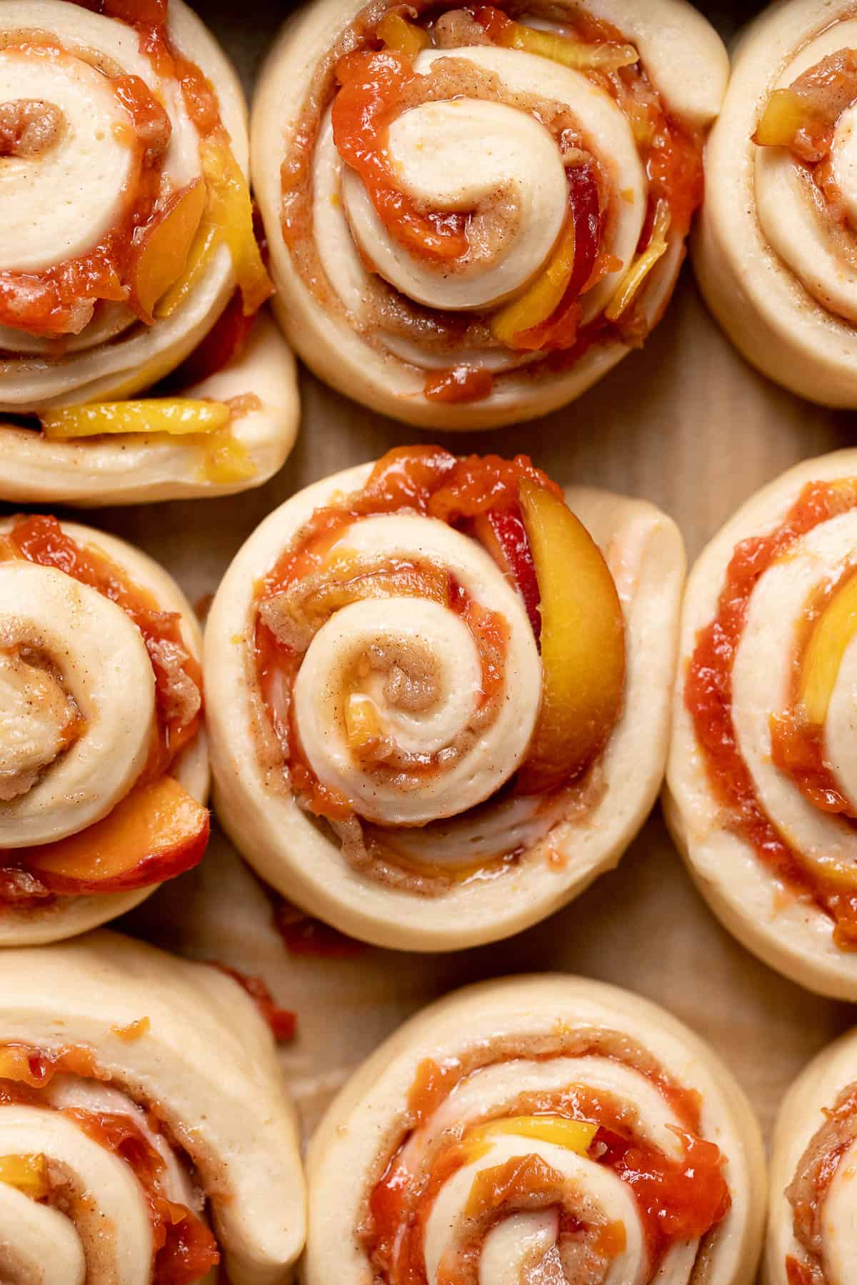 Peach rolls in a baking pan showing how puffy they look and are ready to bake.