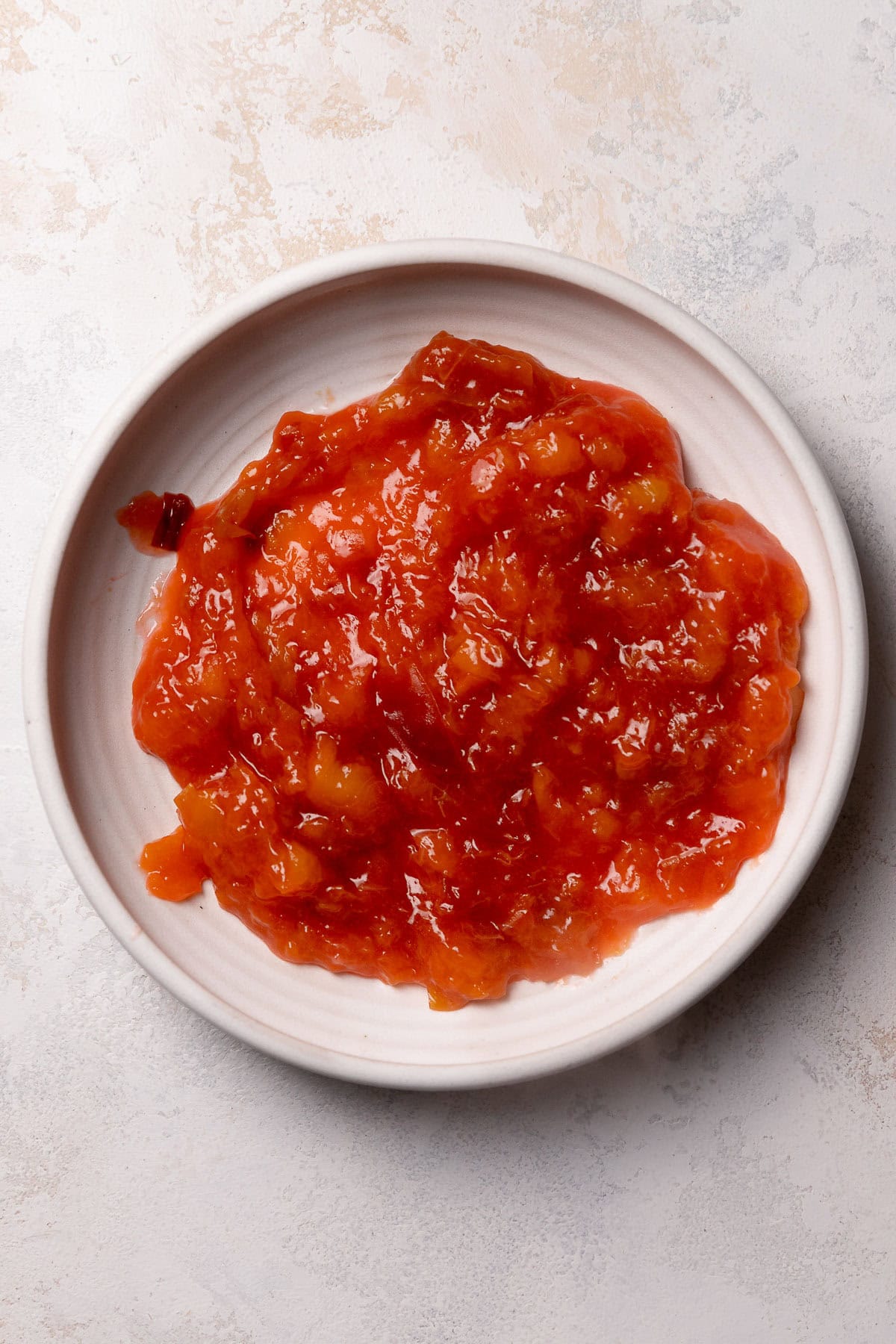 Fresh peach jam in a white bowl.