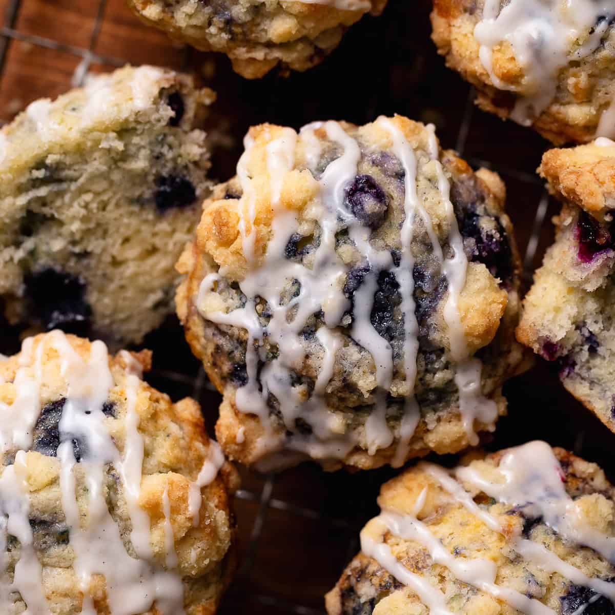 An overhead shot of the crumb topped blueberry muffins drizzled with vanilla glaze.