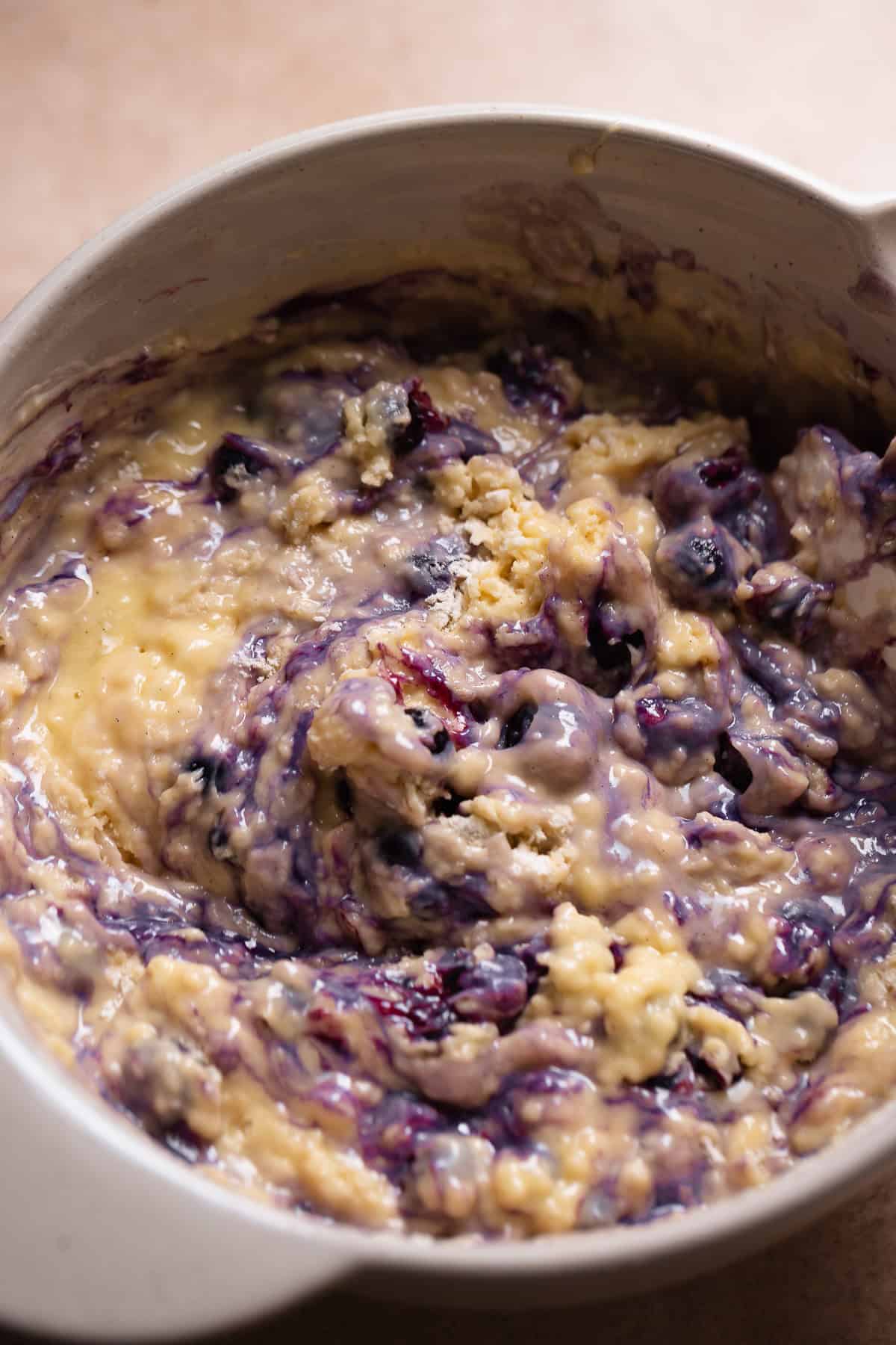 Blueberry muffin batter in a mixing bowl.