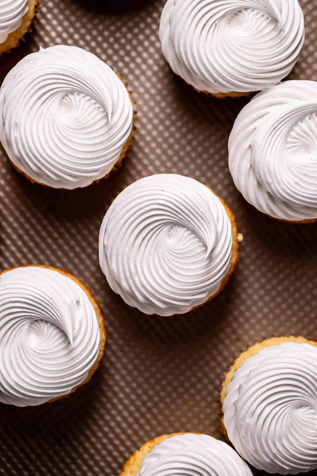 The tops of the cupcakes frosted with meringue frosting.