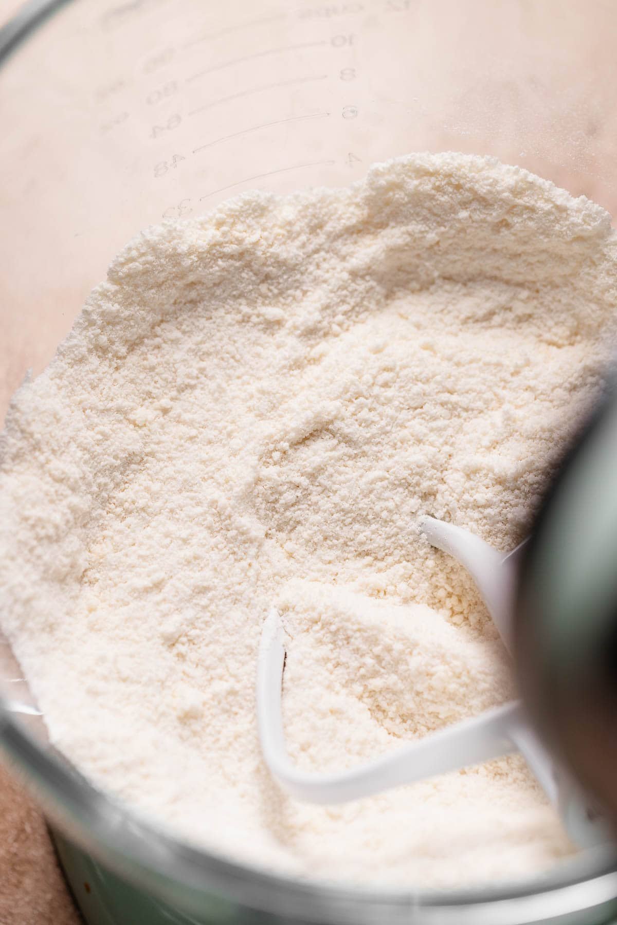 A crumbly dry mixture in a stand mixer bowl.