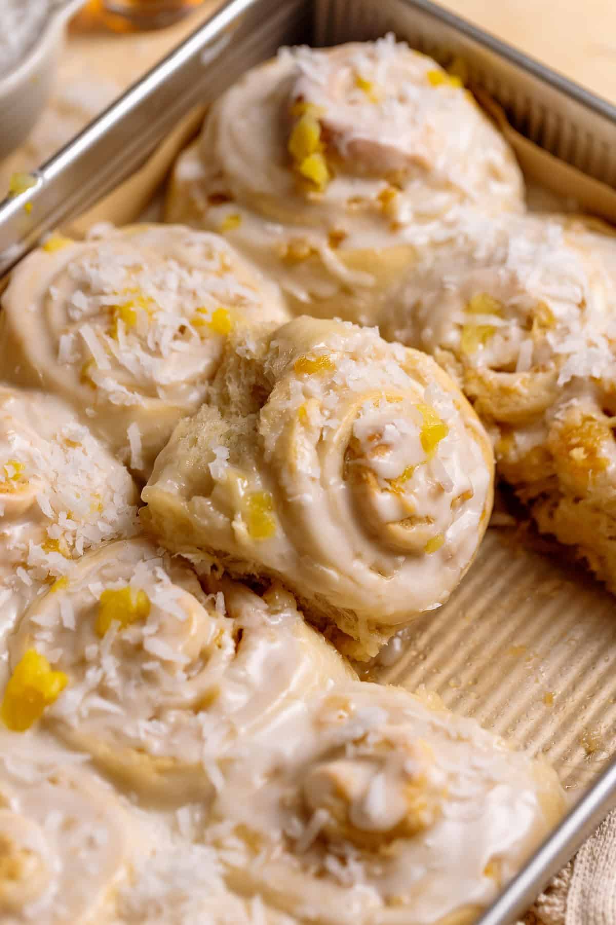 Pineapple coconut rolls in a baking pan.