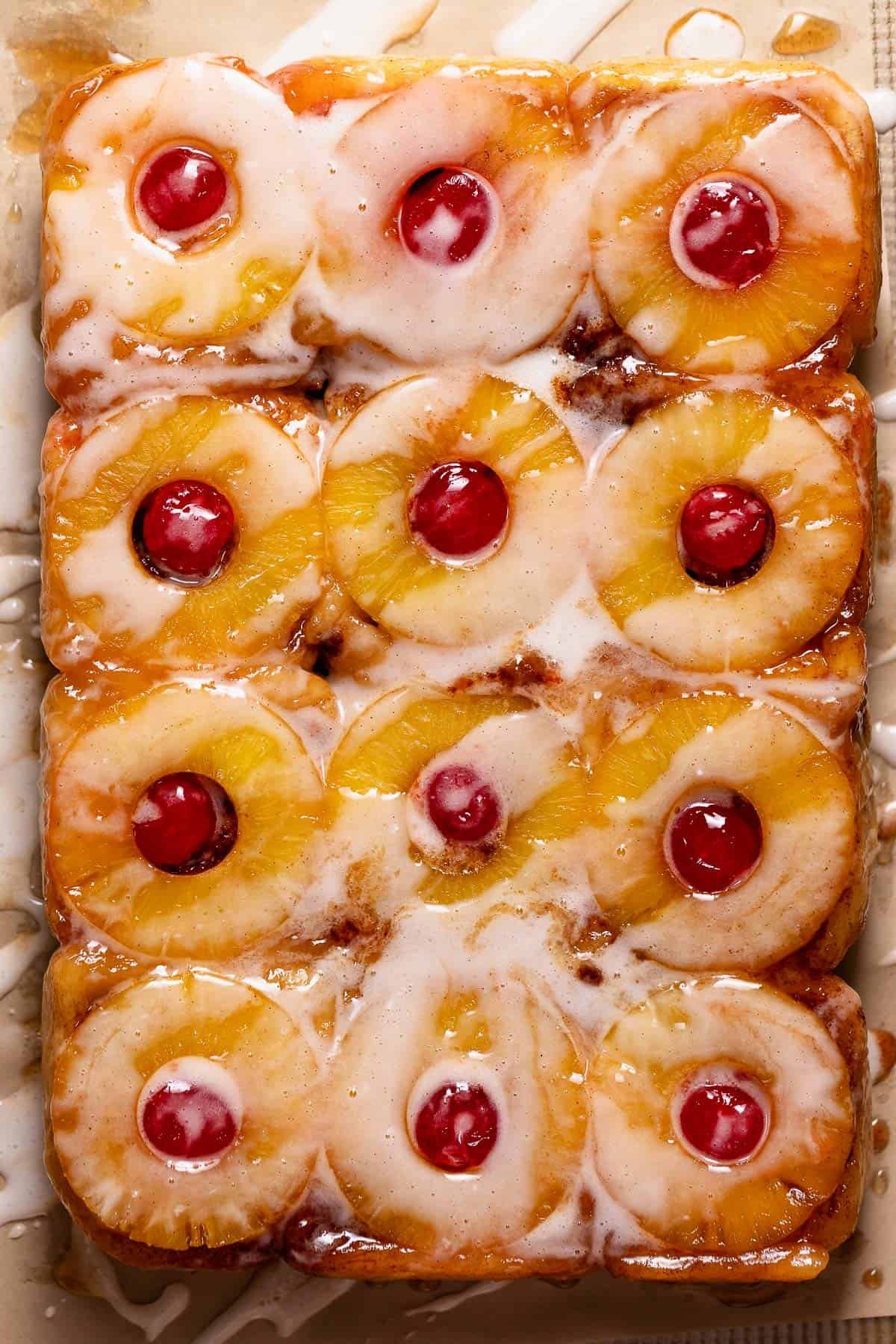 The flipped cinnamon rolls on a pan to show the caramelized pineapple tops.