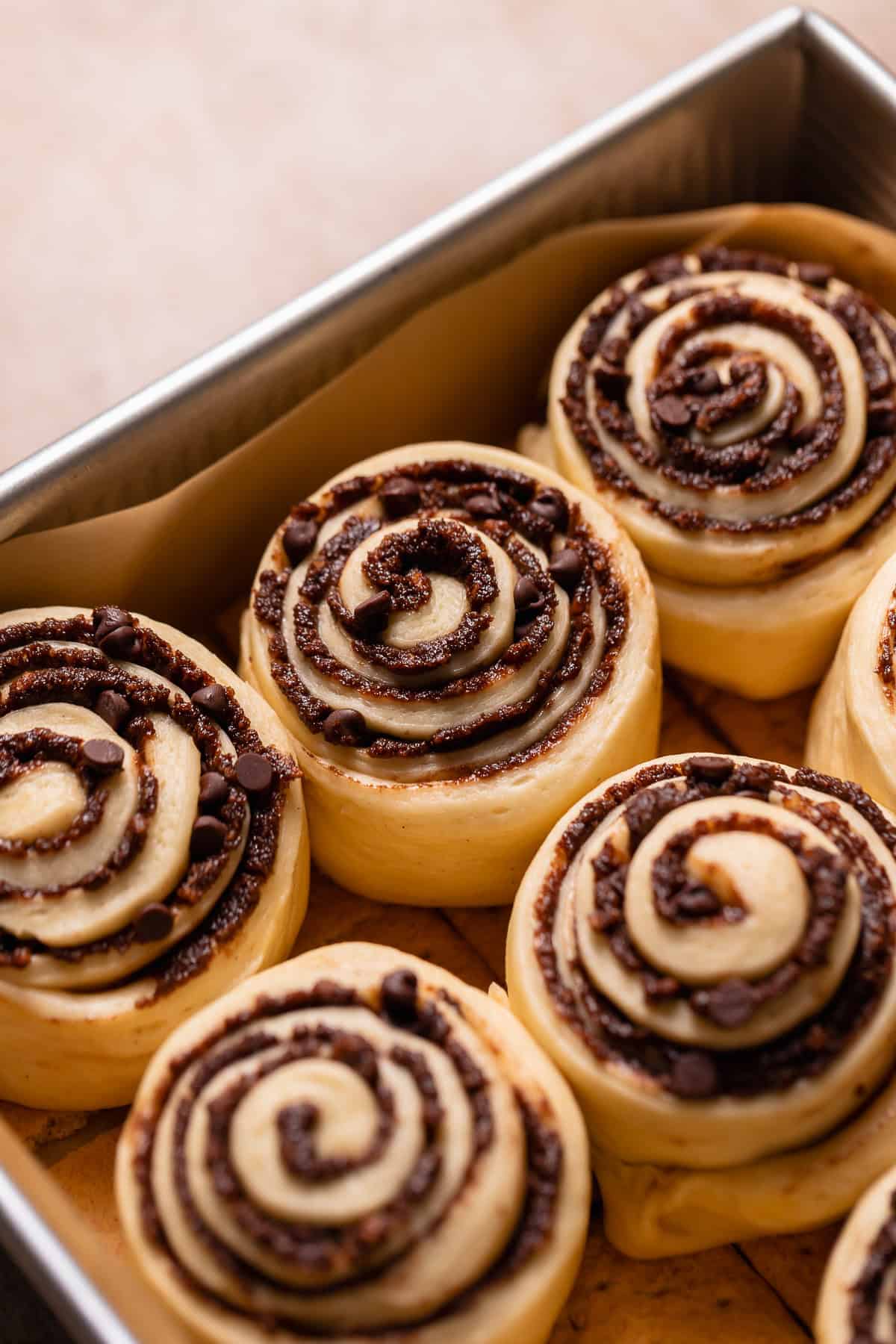 Cinnamon rolls in a baking pan showing they have doubled in size.