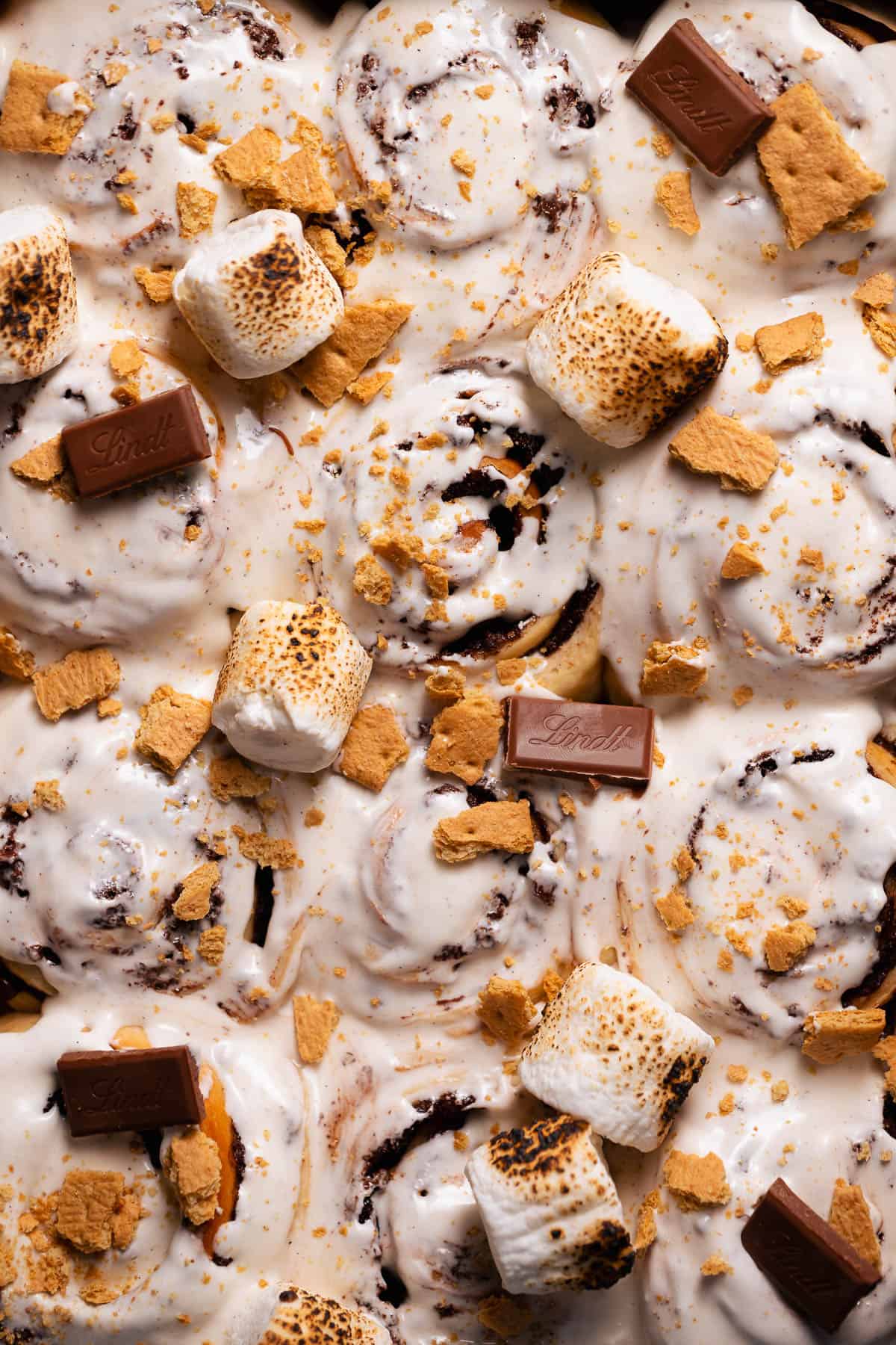 An overhead shot of the smores rolls topped with marshmallow glaze and toasted marshmallows.