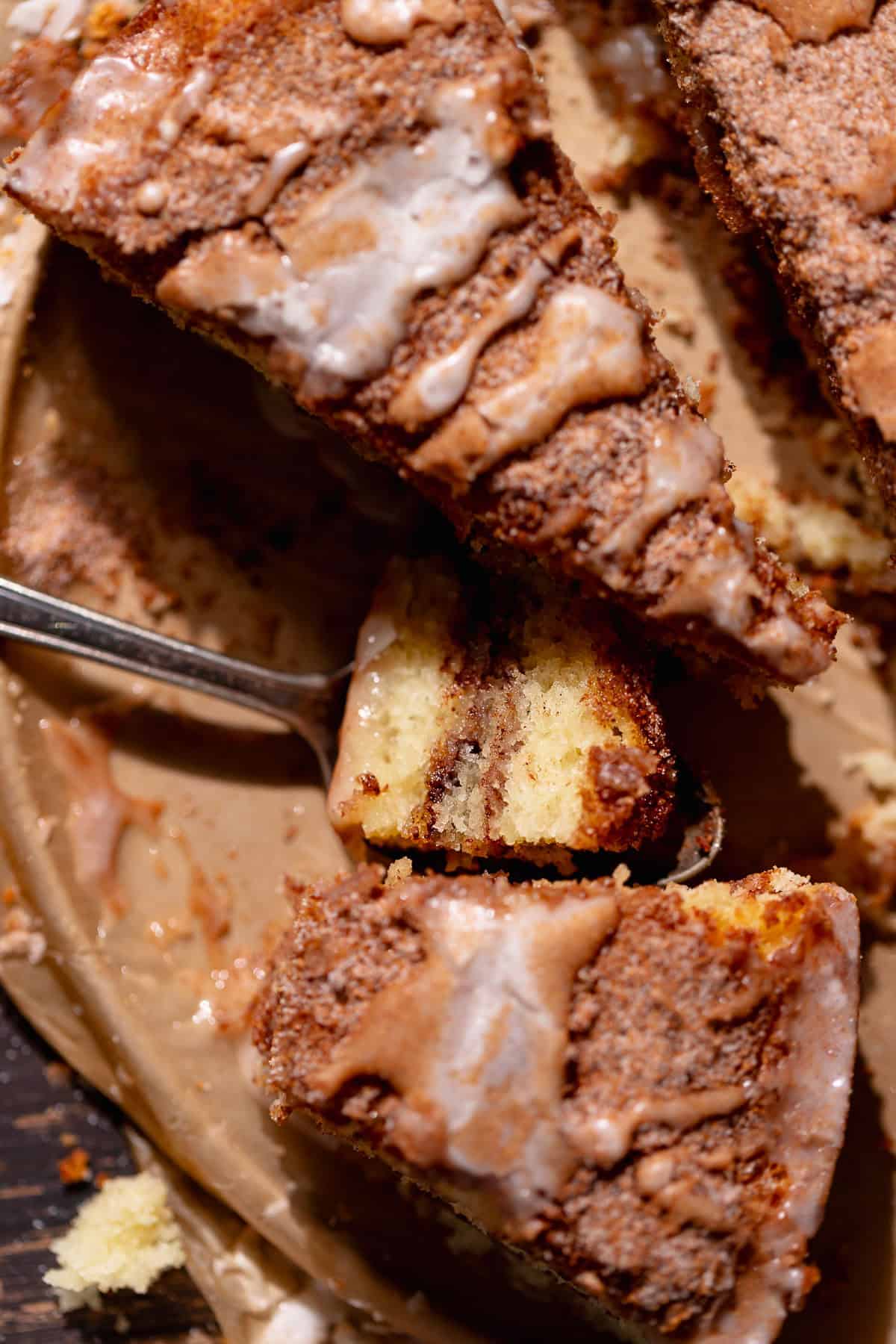 A bite of cinnamon sugar coffee cake on a spoon.