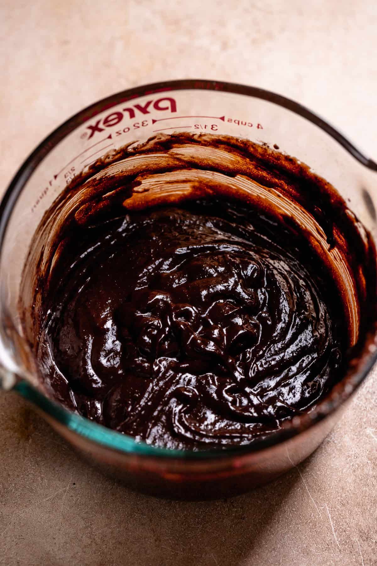 Chocolate filling for the smores bars in a glass measuring cup.
