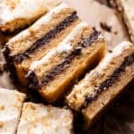 Graham cracker cookie bars with marshmallow frosting and chocolate filling.