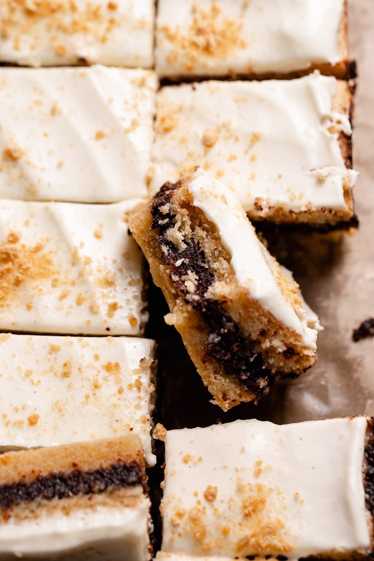A single smores square leaning on the others missing a bite.
