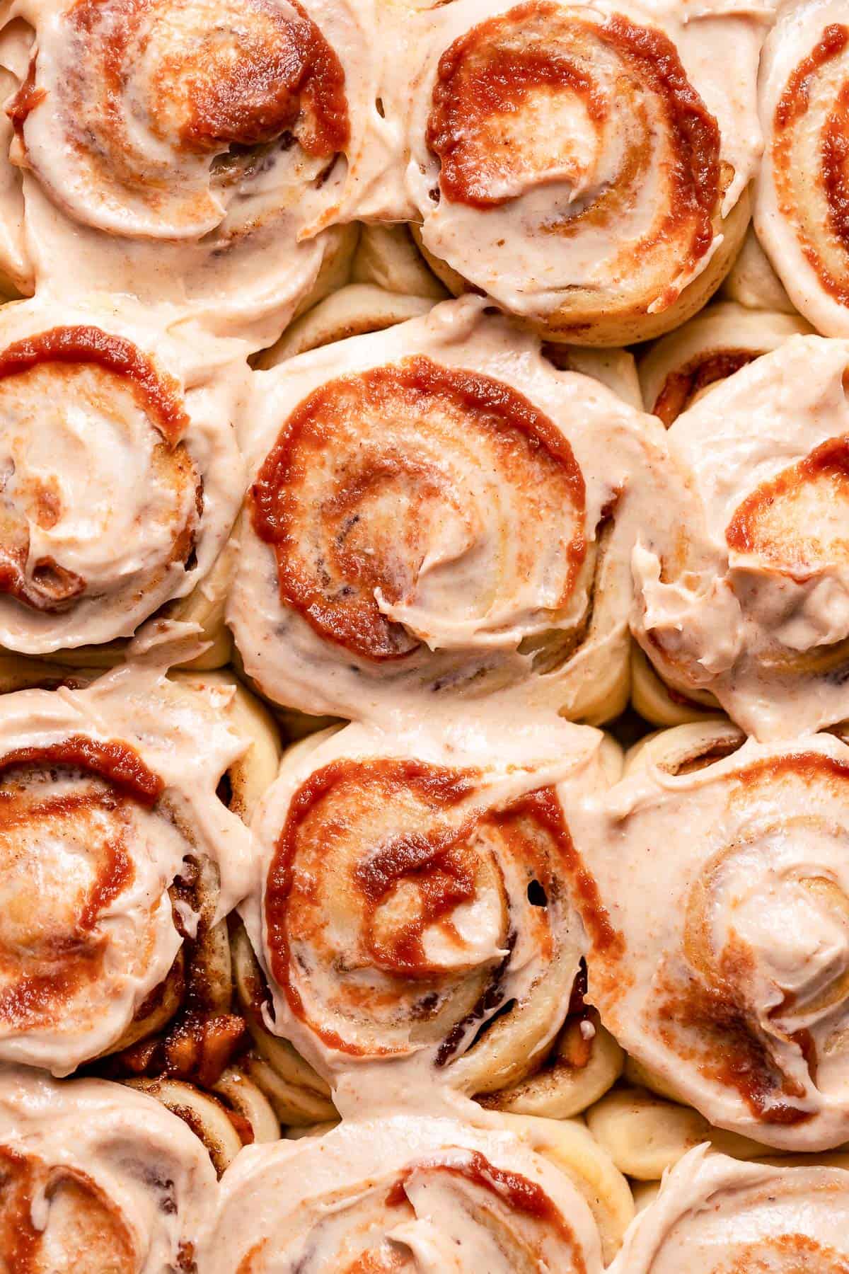Cinnamon apple rolls with cream cheese frosting and a swirl of apple butter.