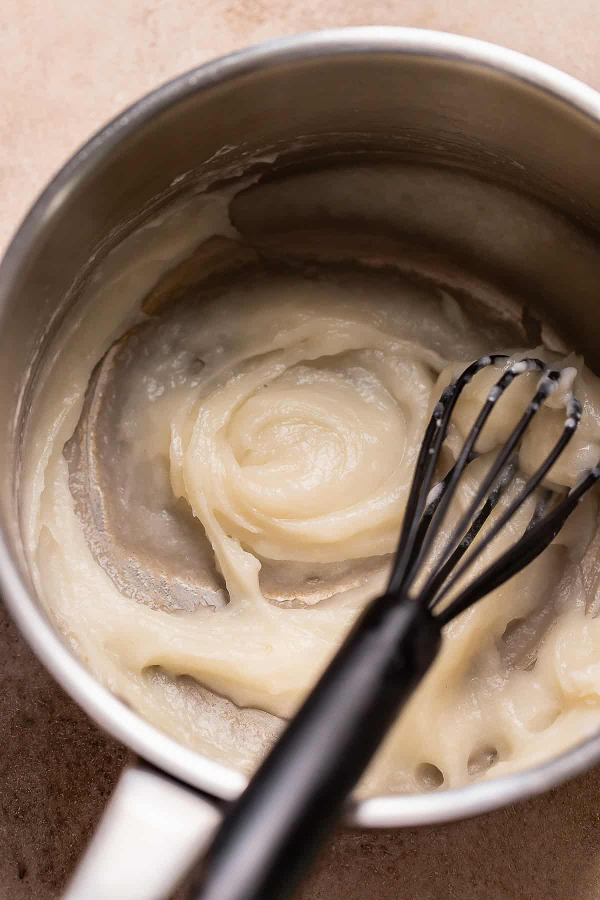 Cooked tangzhong roux in a pot being whisked.