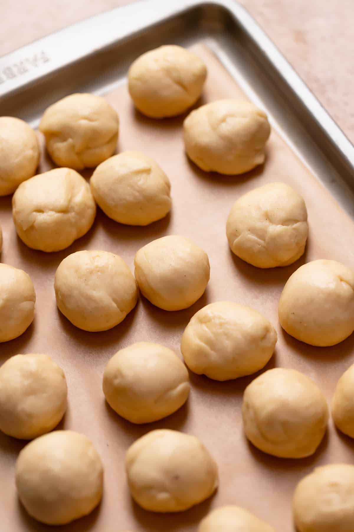 Cinnamon roll dough portioned into dough balls for the monkey bread.