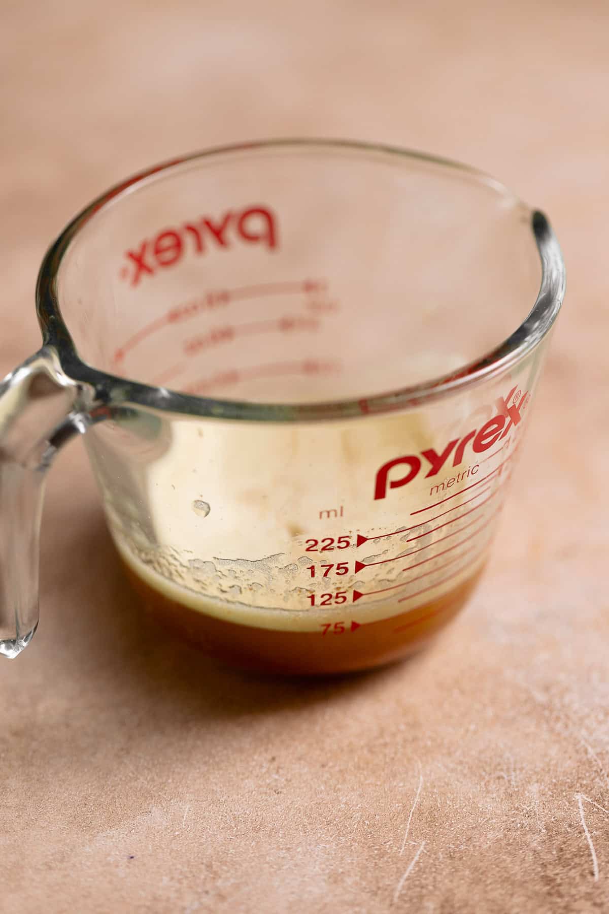 Brown butter in a glass pyrex measuring cup.