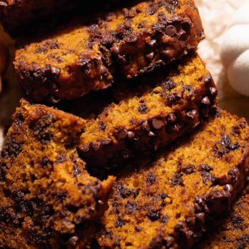 Slices of chocolate chip pumpkin bread laying on top of each other.