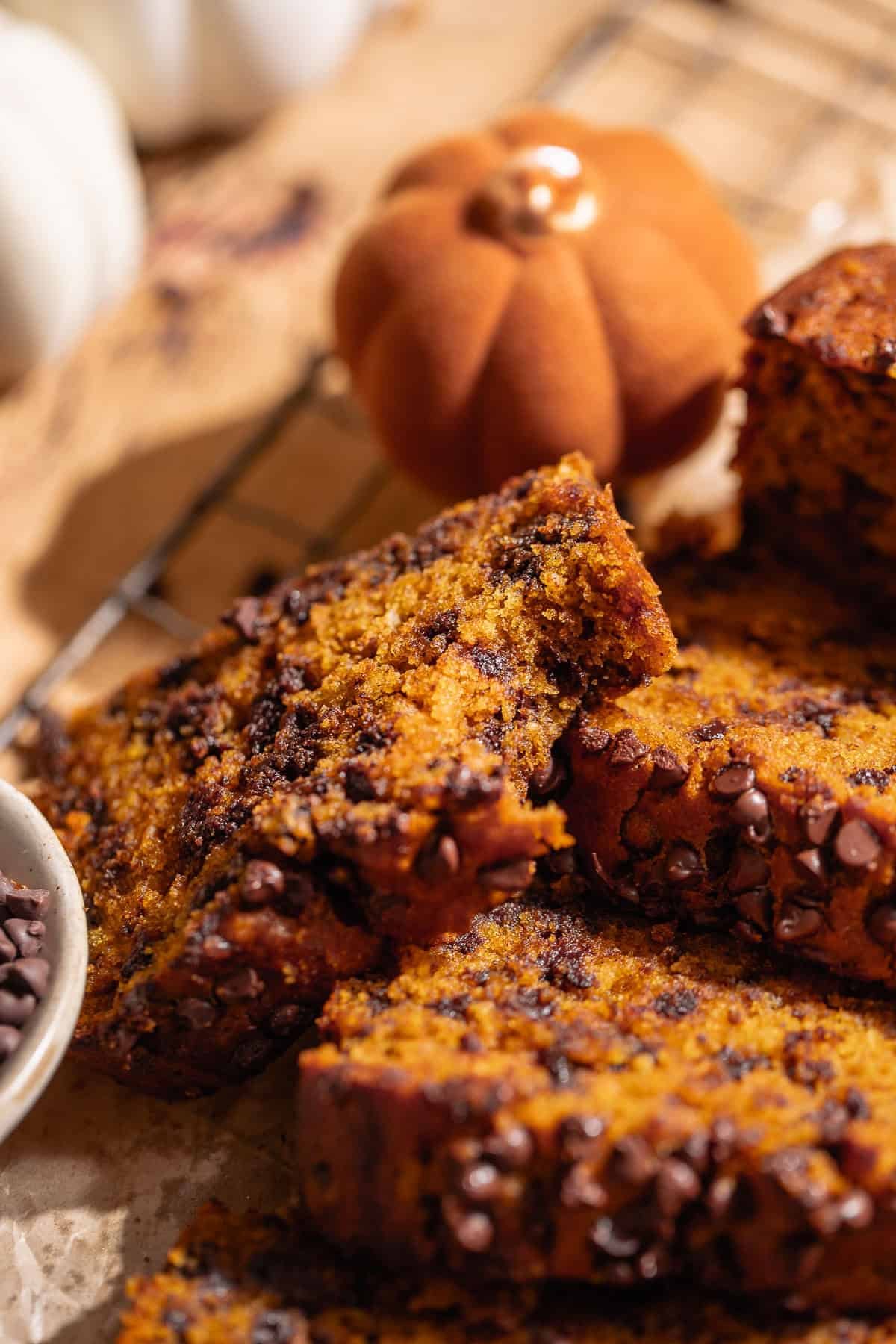 A slice of chocolate pumpkin loaf with a bite taken out of it.