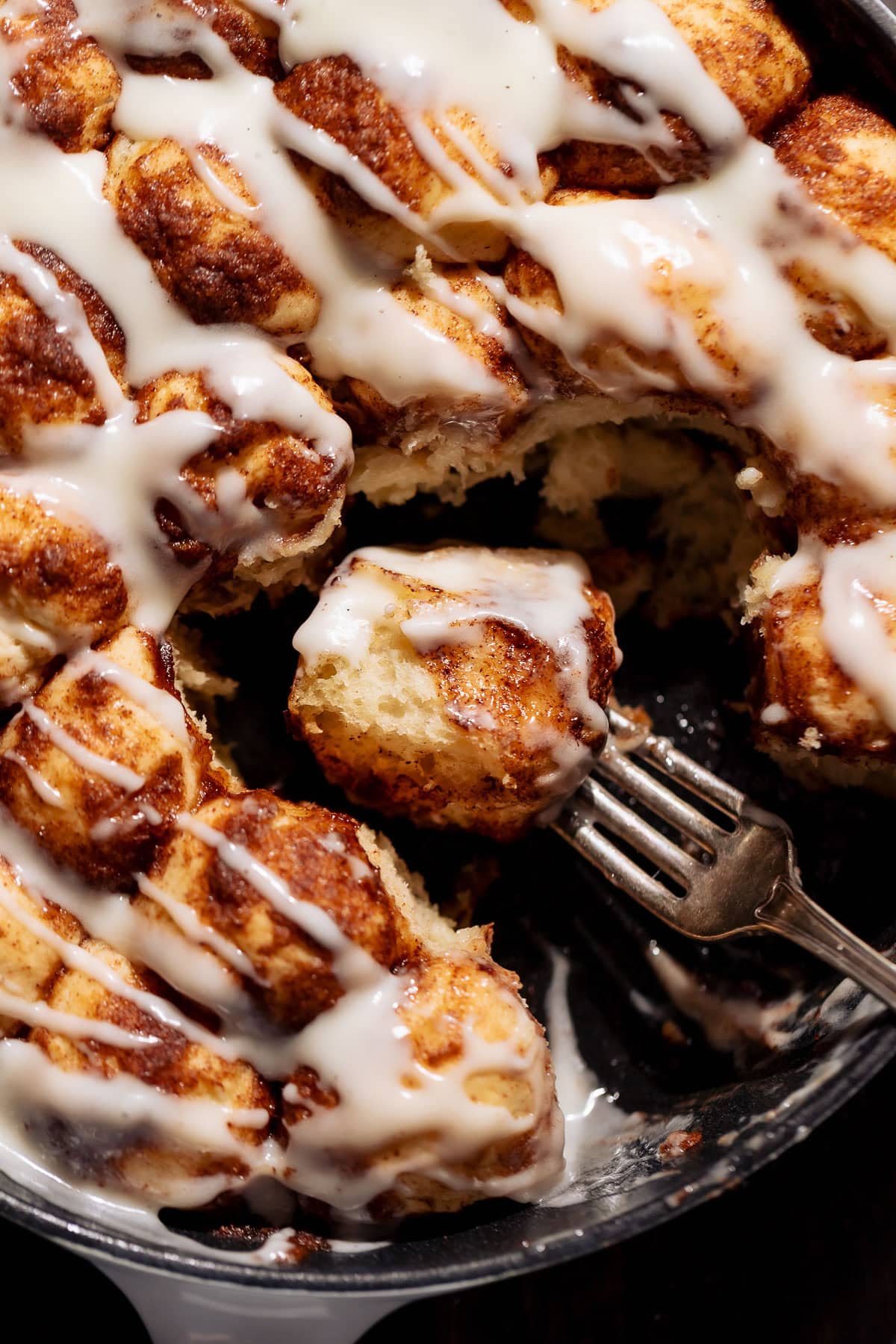 A bite of cinnamon roll monkey bread on a fork.